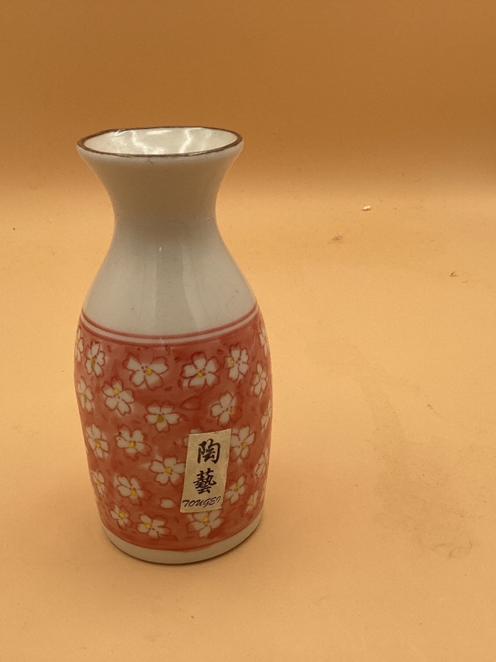 Sake bottle with a pink cherry blossom design